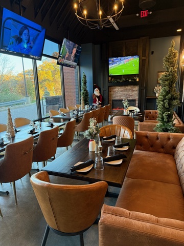 Long table with leather banquette seating in the Clubhouse private event room in Edwardsville, Illinois